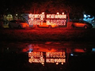 The night market sign reflecting in the river